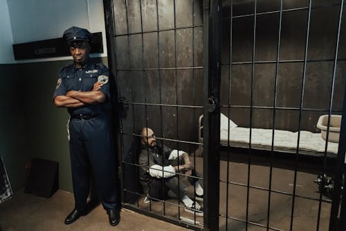 A Policeman Guarding a Prisoner in Jail