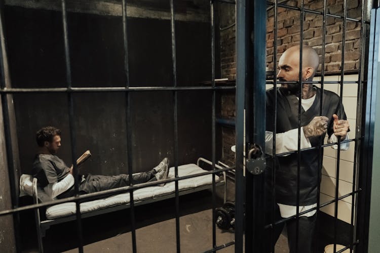 Men Together Inside A Prison Cell