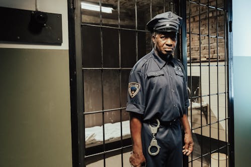 A Jail Guard Standing in a Prison Cell