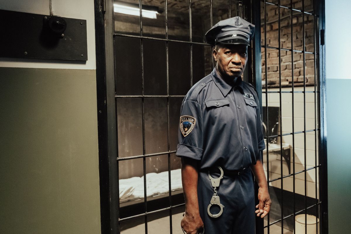 Corrections officer in uniform facing the camera at a correctional facility — corrections officer mortgage programs from a lender who understands law enforcement