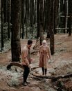 Man and Woman Walking on Forest