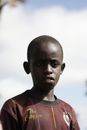 A Boy Wearing a Dirty Red Jersey