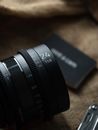 Black Camera Lens on Brown Wooden Table