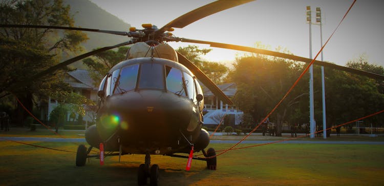 Black Chopper On Green Grass Lawn During Daytime