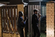 Police Officer Entering a House While Holding Guns