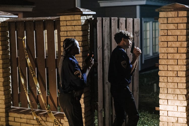 Police Officer Entering A House While Holding Guns 