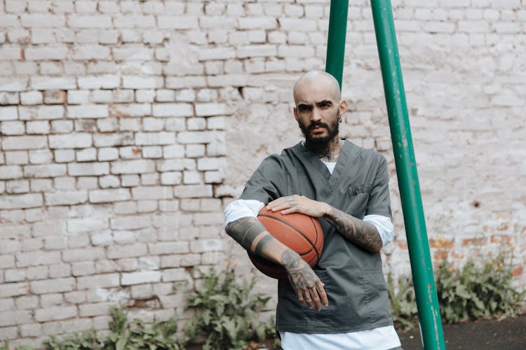 Man Holding Basketball In Jail Yard