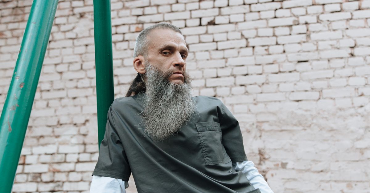 Bearded Inmate Bearded Inmate Standing near a Brick Wall · Free Stock Photo