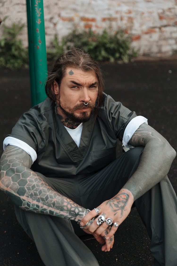 A Male Inmate Sitting On The Ground