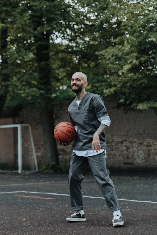 Smiling Prisoner Playing Basketball in Jail Yard