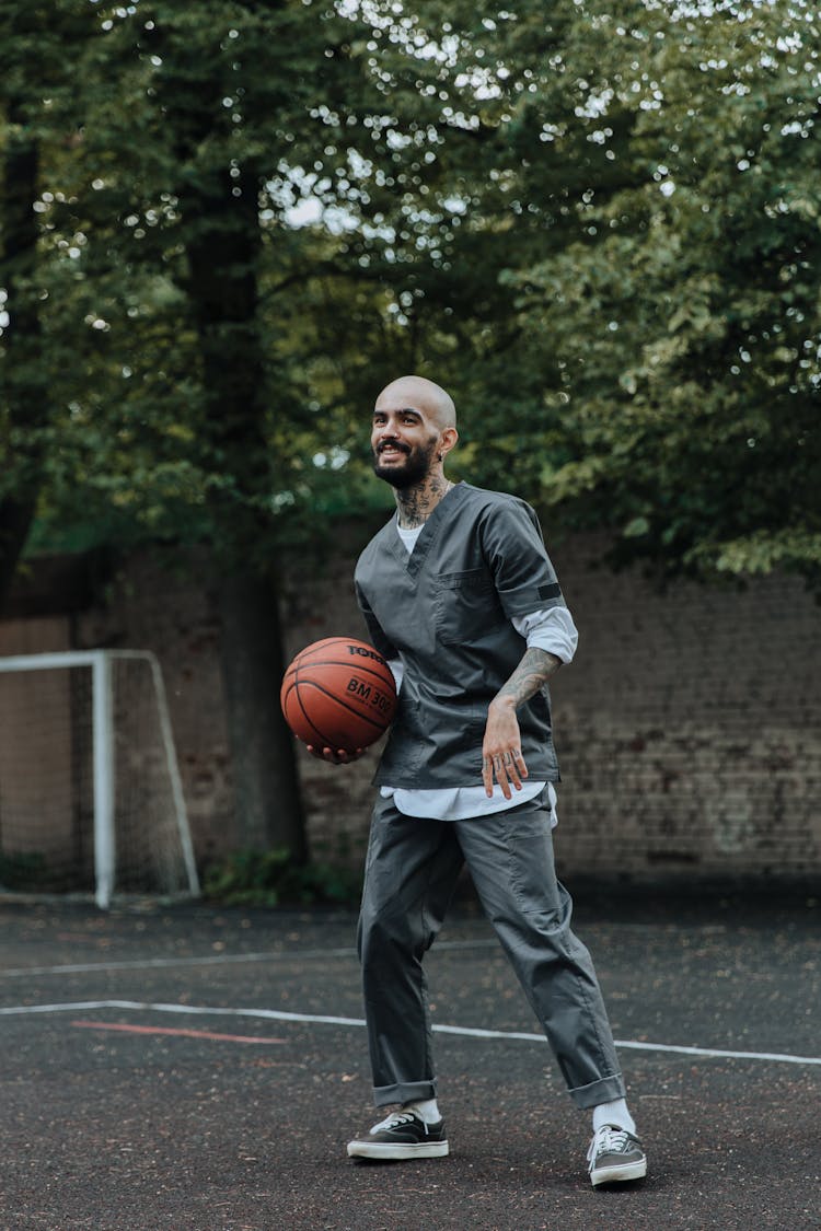 Smiling Prisoner Playing Basketball In Jail Yard