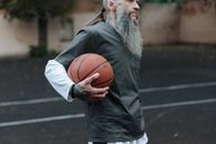 Man in Black Long Sleeve Shirt Holding Basketball