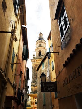 Explore the narrow streets of Menton in Provence-Alpes-Côte d'Azur, showcasing charming architecture and historic landmarks. by Lalla Choukri Alaoui