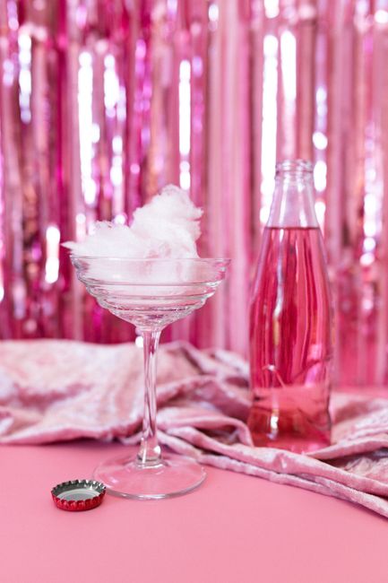 Festive pink drink setup with glamourous background lighting.