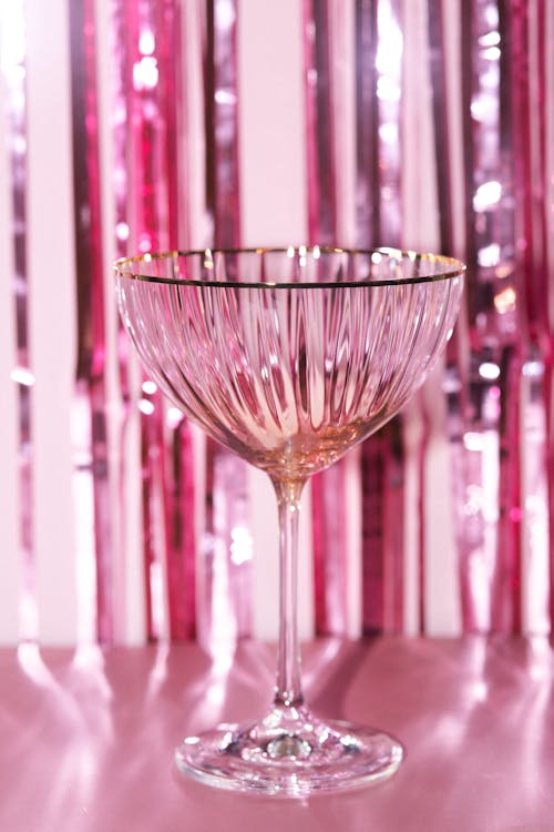 A Clear Wine Glass with Gold Rim 