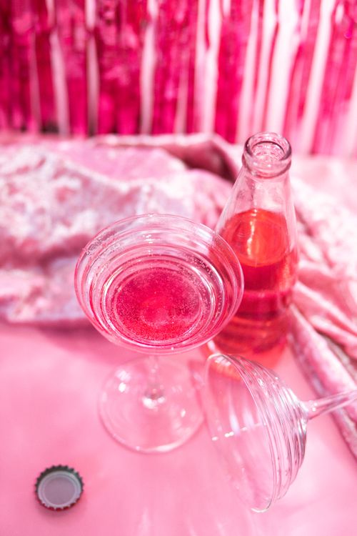 Free A close-up of an elegant pink drink with glassware and a velvet backdrop. Stock Photo