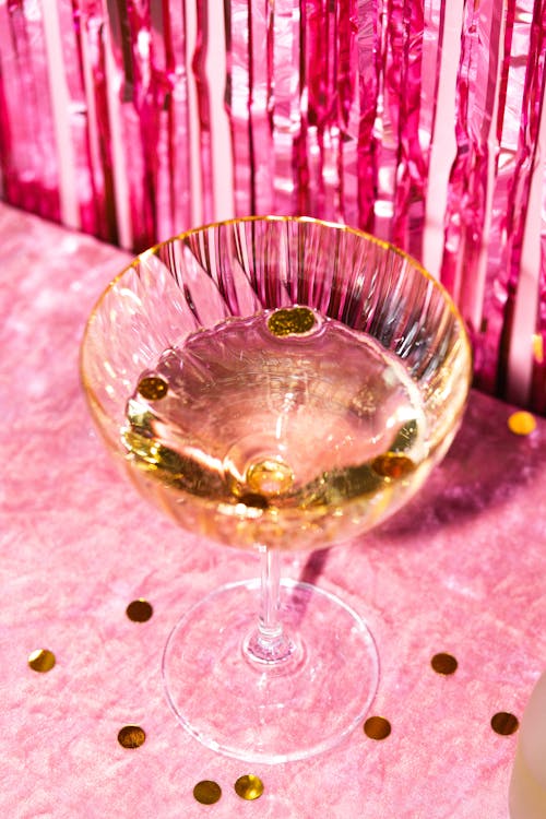 High-Angle Shot of a Wineglass on Pink Background