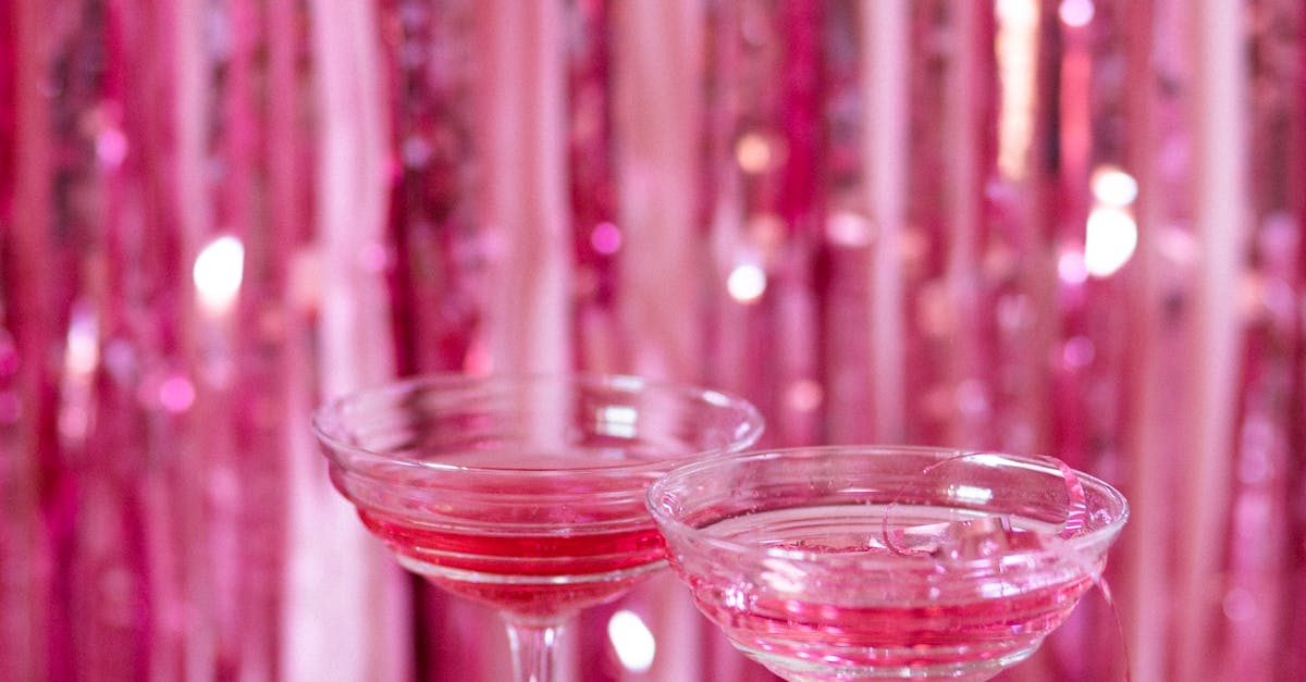 A refreshing glass of sangria with fresh fruit slices and a sprig of mint on a wooden table.