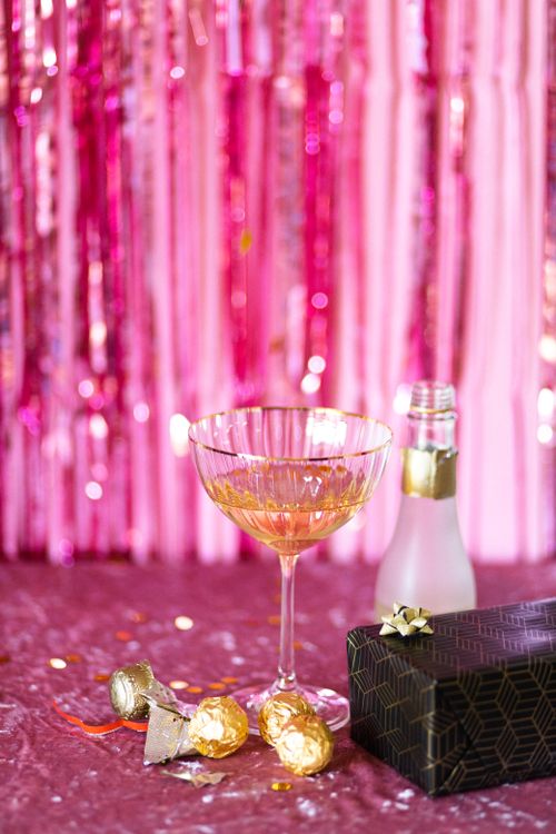 Free A chic pink-themed celebration scene featuring champagne, a gift box, and confetti, perfect for any festive occasion. Stock Photo