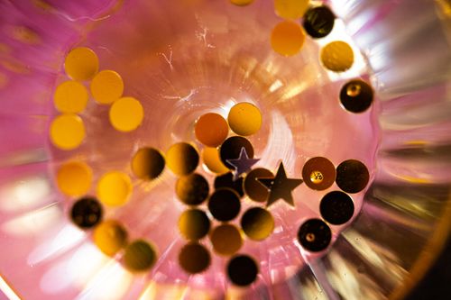 Free Vibrant confetti in a glass bowl with a festive atmosphere. Stock Photo