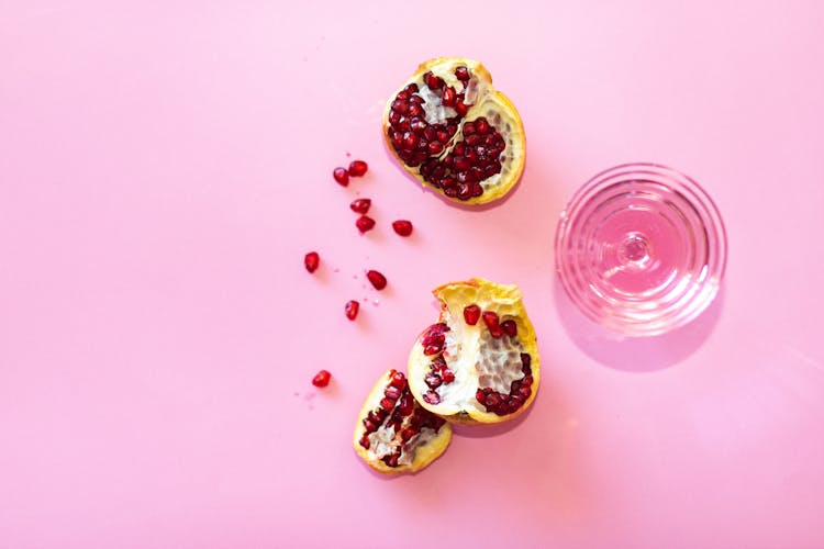 Pomegranate Fruit On Pink Surface 