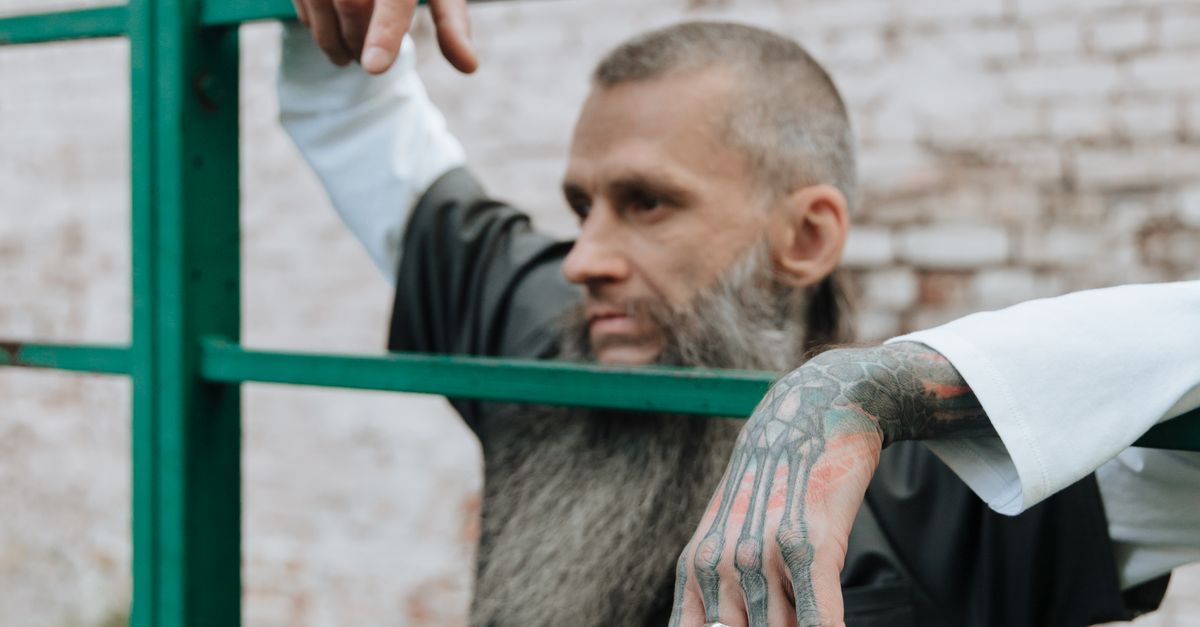 Bearded Inmate Bearded Man in Metal Prison Bar · Free Stock Photo