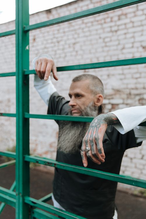 Bearded Inmate Bearded Man in Metal Prison Bar · Free Stock Photo