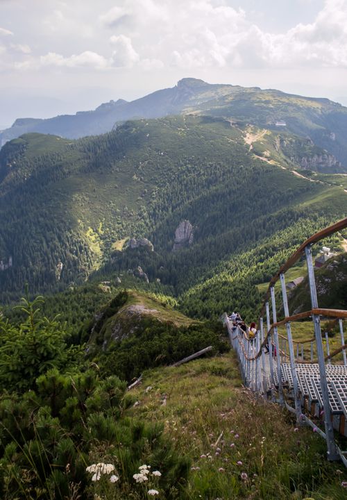 Free Breathtaking view of lush green mountains with a steel staircase descending through. Stock Photo