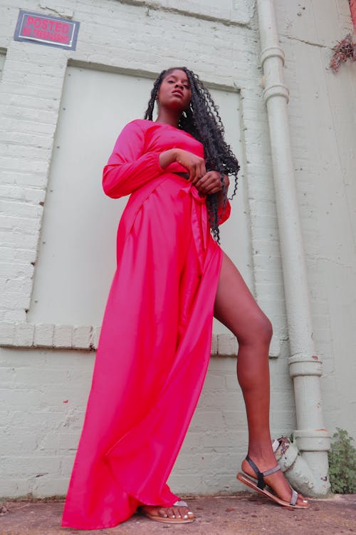 Low Angle Shot of Woman Wearing Neon Pink Maxi Dress 