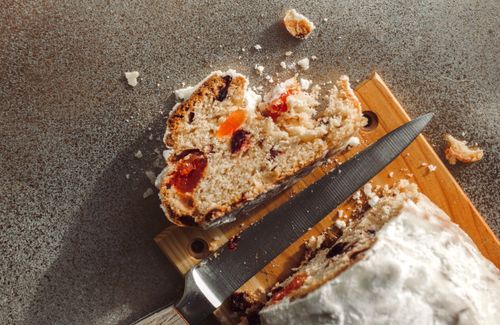 Free Rustic close-up of fruit cake slice with knife on cutting board, highlighting delicious textures. Stock Photo