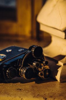 Close-up of a vintage film camera on a rustic table, capturing a warm retro ambiance.