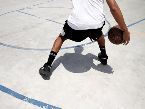 Man in White Top Playing Basketball