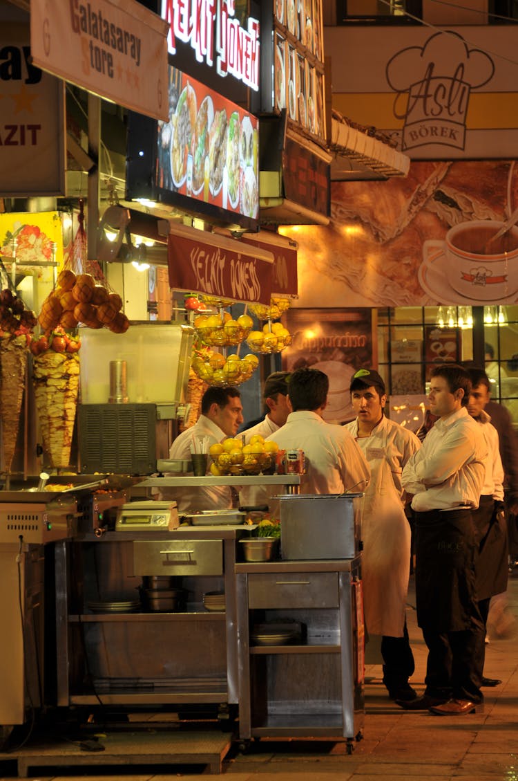 Discussion Of Cooks And Waiters In Front Of The Restaurant At A Kebab Booth