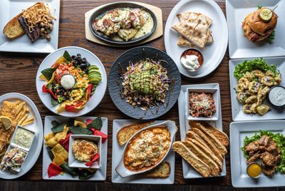 Overhead view of a full table of plated dishes — photo by Alberta Studios on Pexels