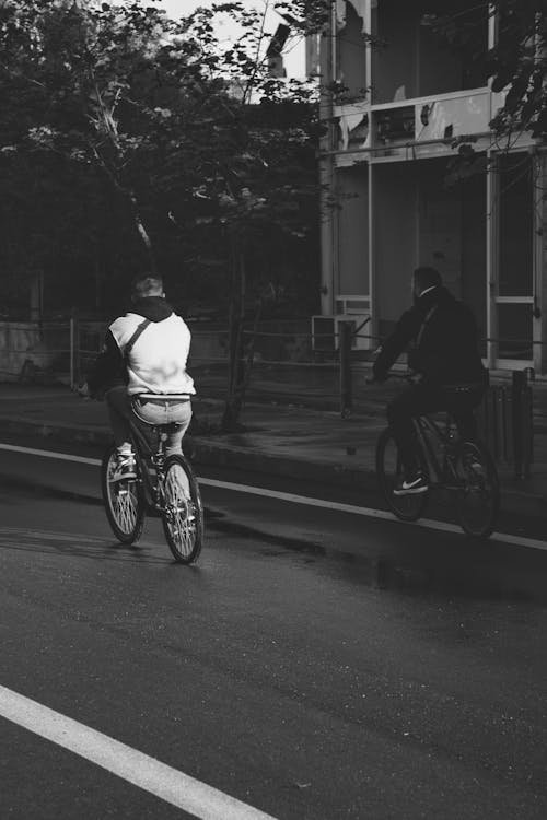 Free Black and White Photo of Men Riding Bicycles Stock Photo