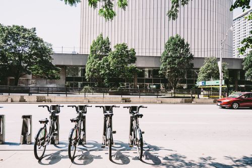 Free Row of bicycles parked in downtown Toronto, surrounded by modern architecture. Stock Photo