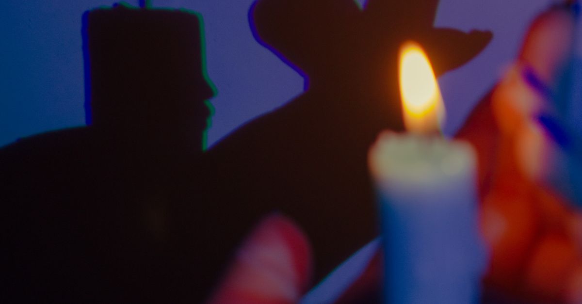 Hand Holding Wax Candle and Shadow · Free Stock Photo