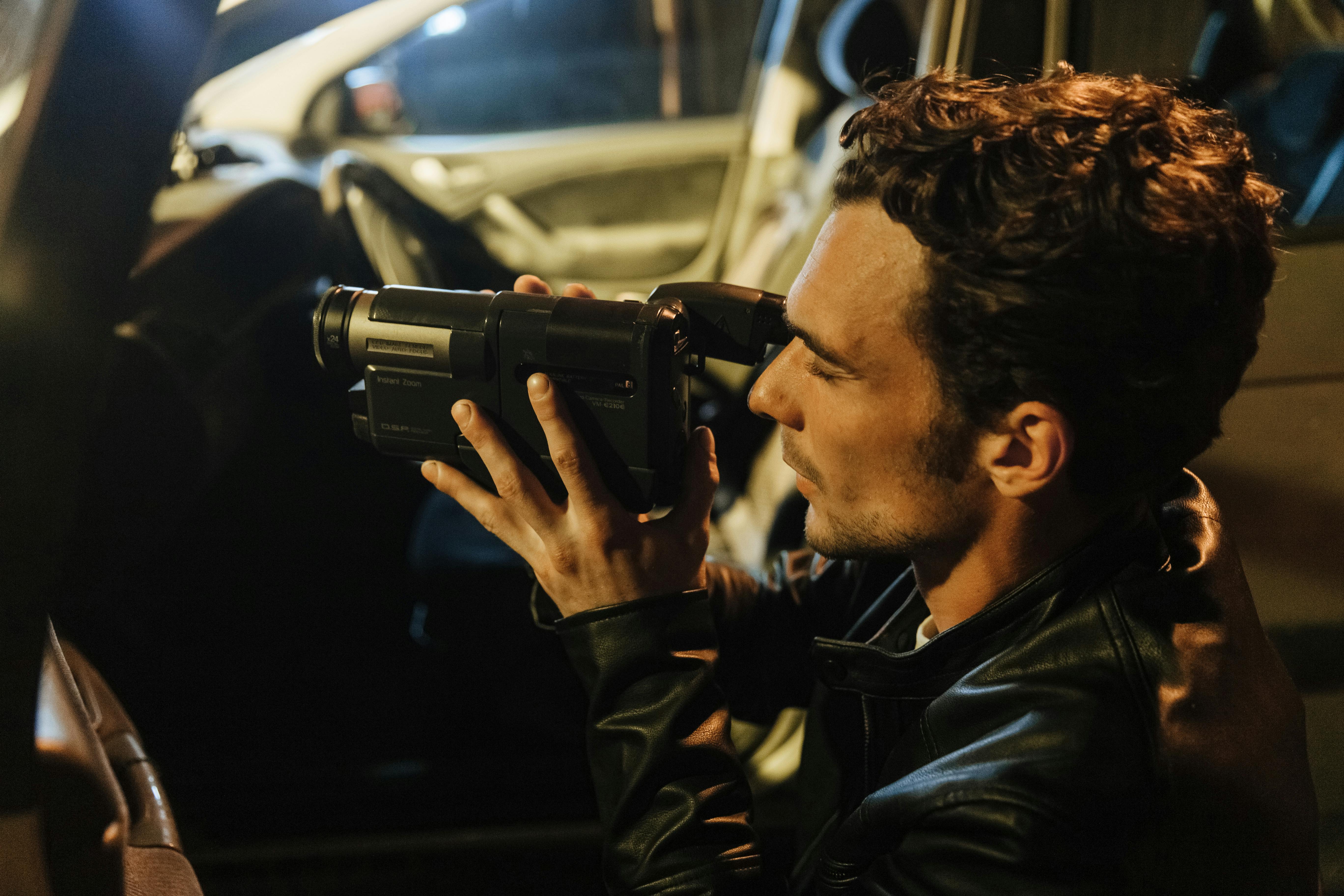 journalist filming from behind the car door