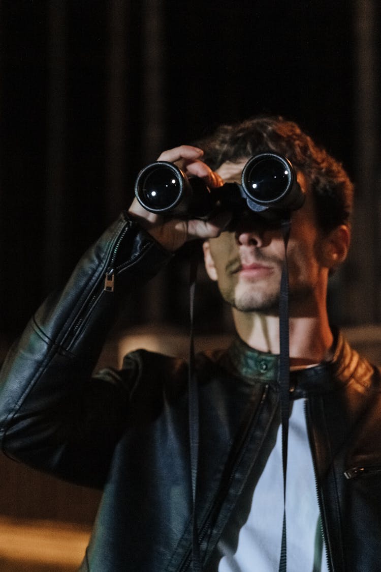 Man Holding Binoculars