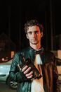 Man in Brown Leather Jacket Holding Black Pistol
