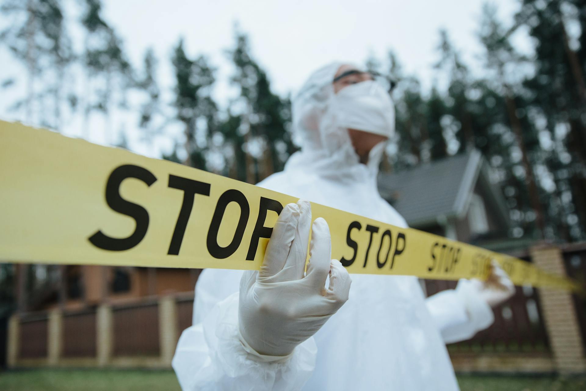 Investigator Holding Yellow Police Tape