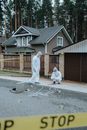People Wearing Personal Protective Equipment Standing in the Crime Scene