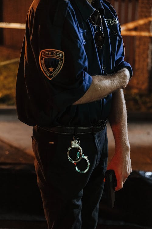 Hanging Handcuffs on Police Man's Pants 
