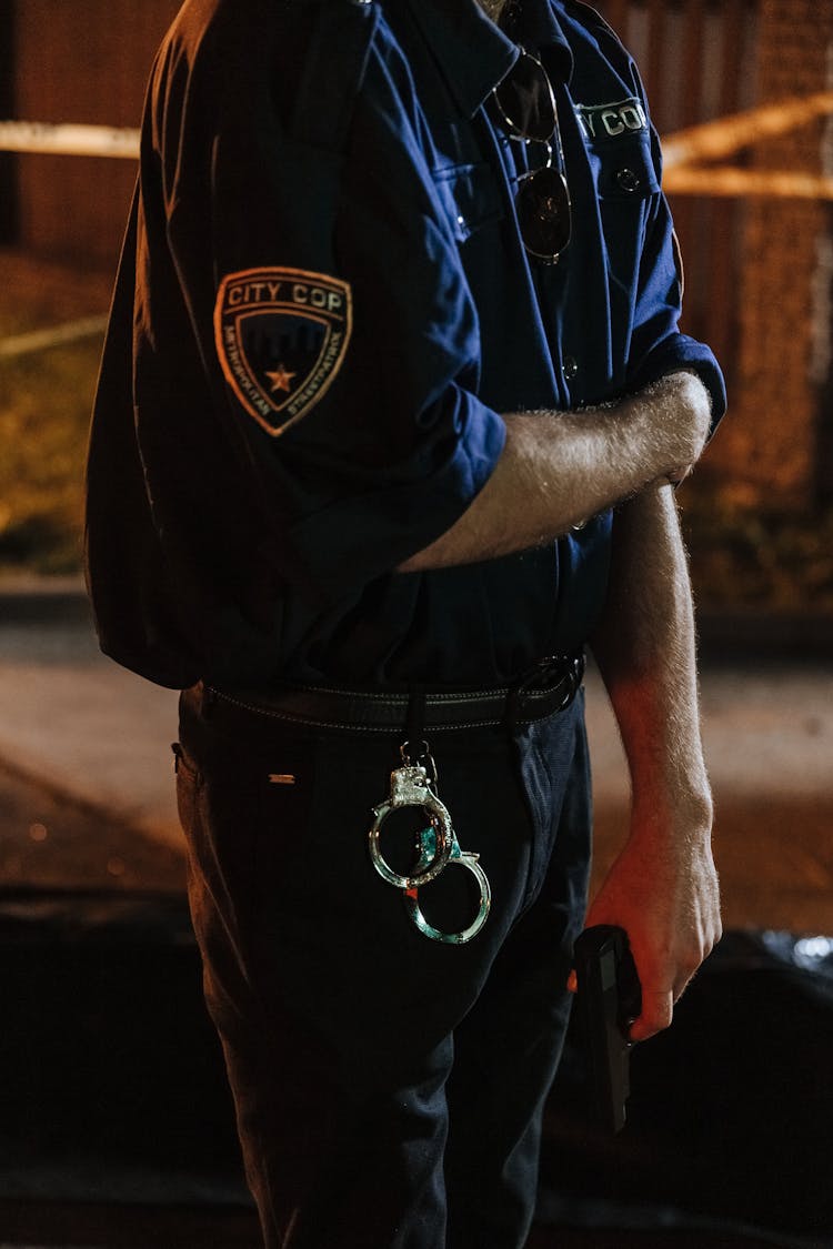 Hanging Handcuffs On Police Man's Pants 