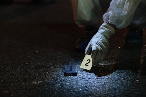 Forensics Investigator Marking an Item on the Street