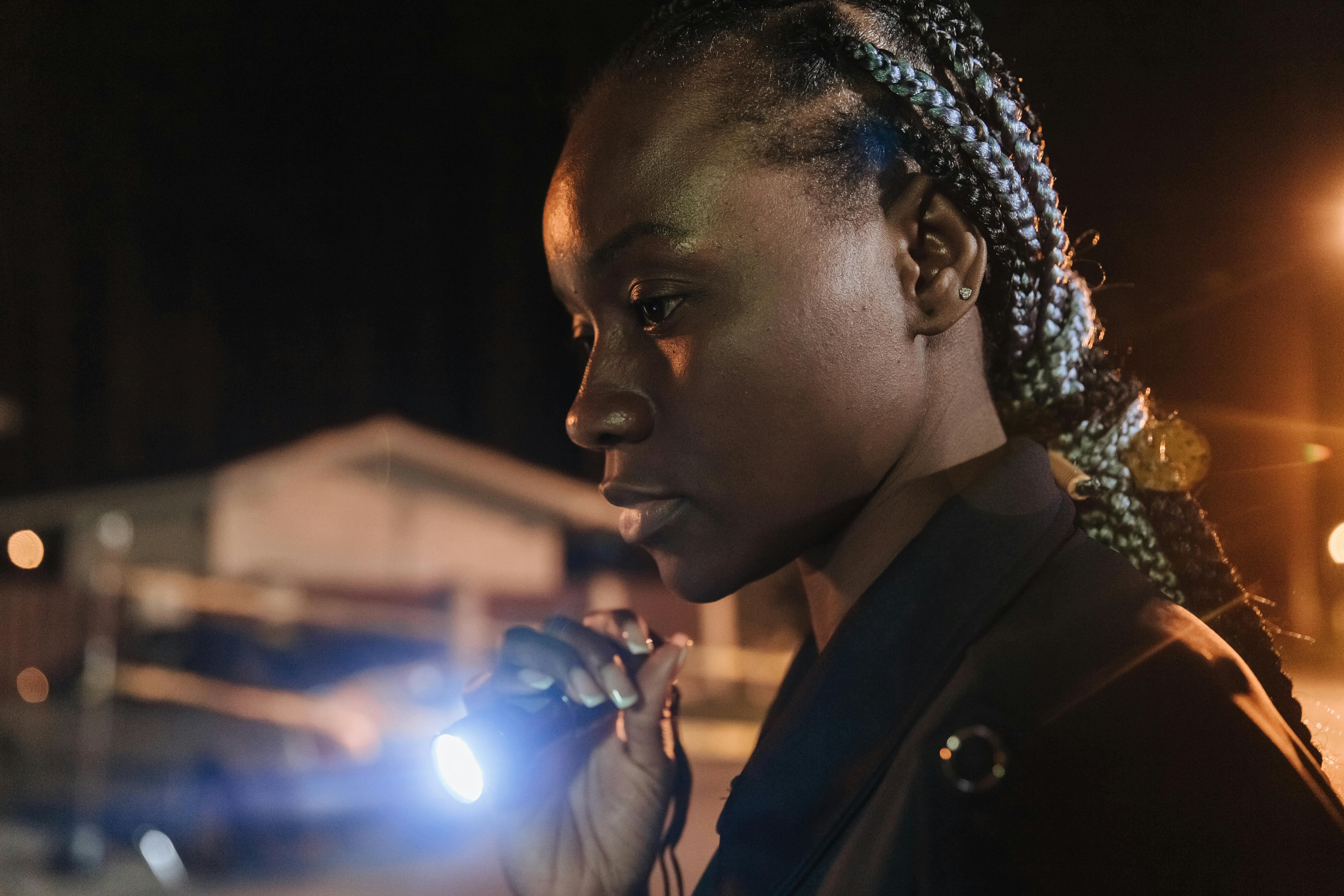 policewoman with flashlight at the crime scene