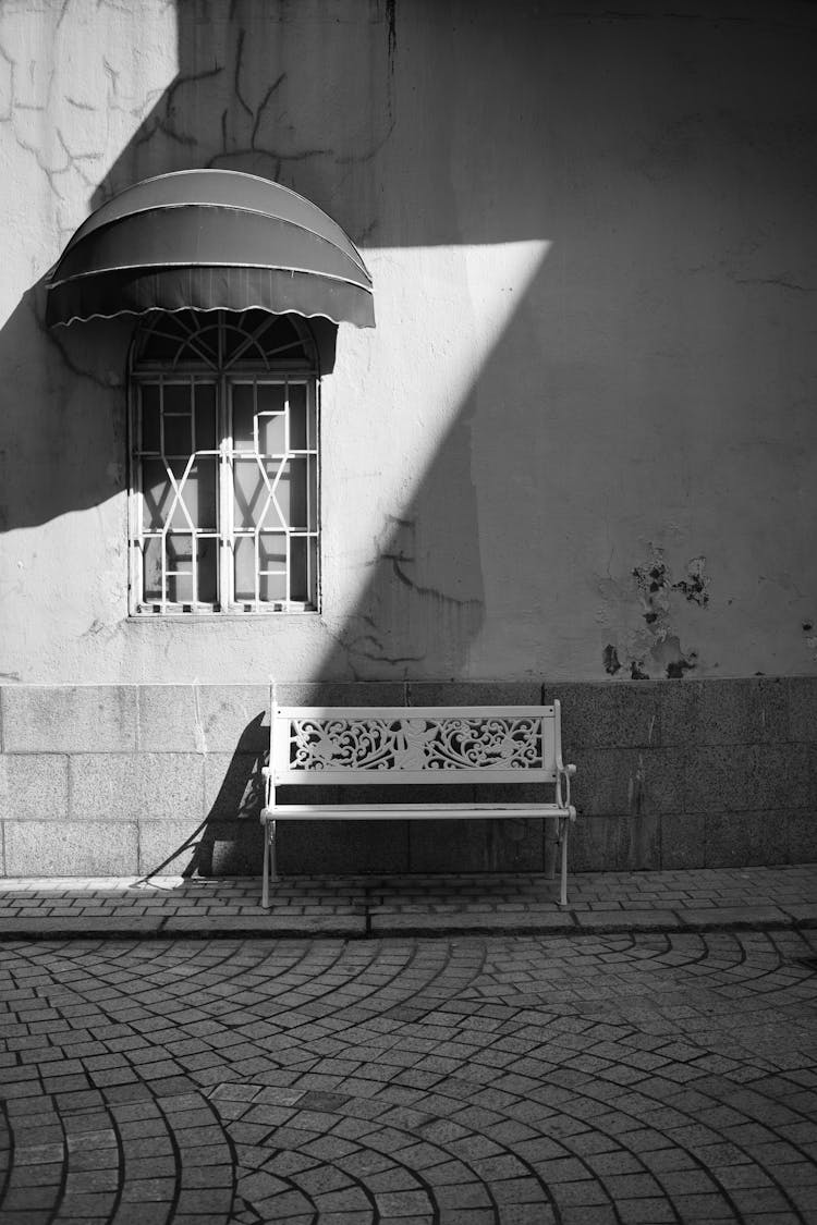 Empty Bench On Paved City Street