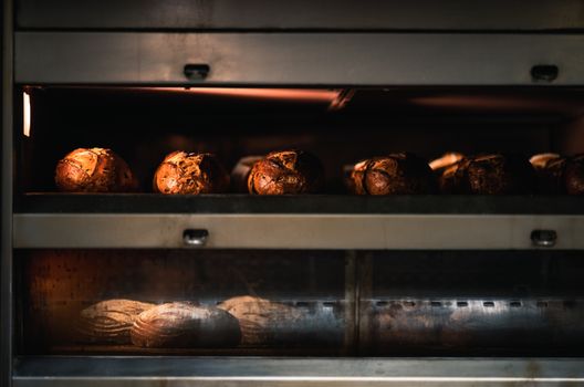 Warm artisan bread being baked to perfection in a professional industrial oven.