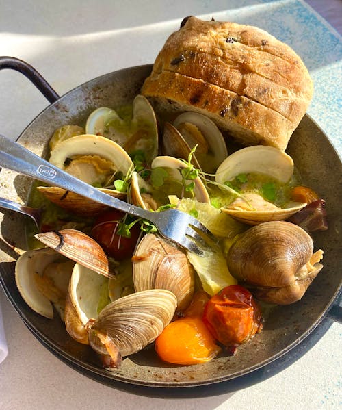 Clams and Raisin Bread in a Stainless Steel Wok 
