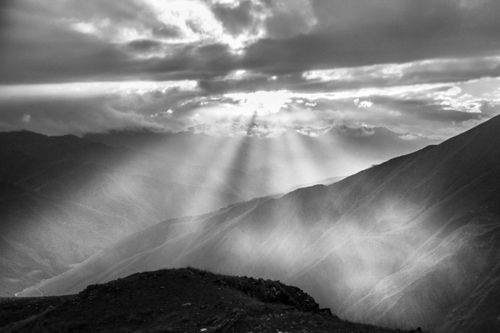 Free Stunning black and white photo of misty mountains with sunbeams through clouds in Georgia. Stock Photo